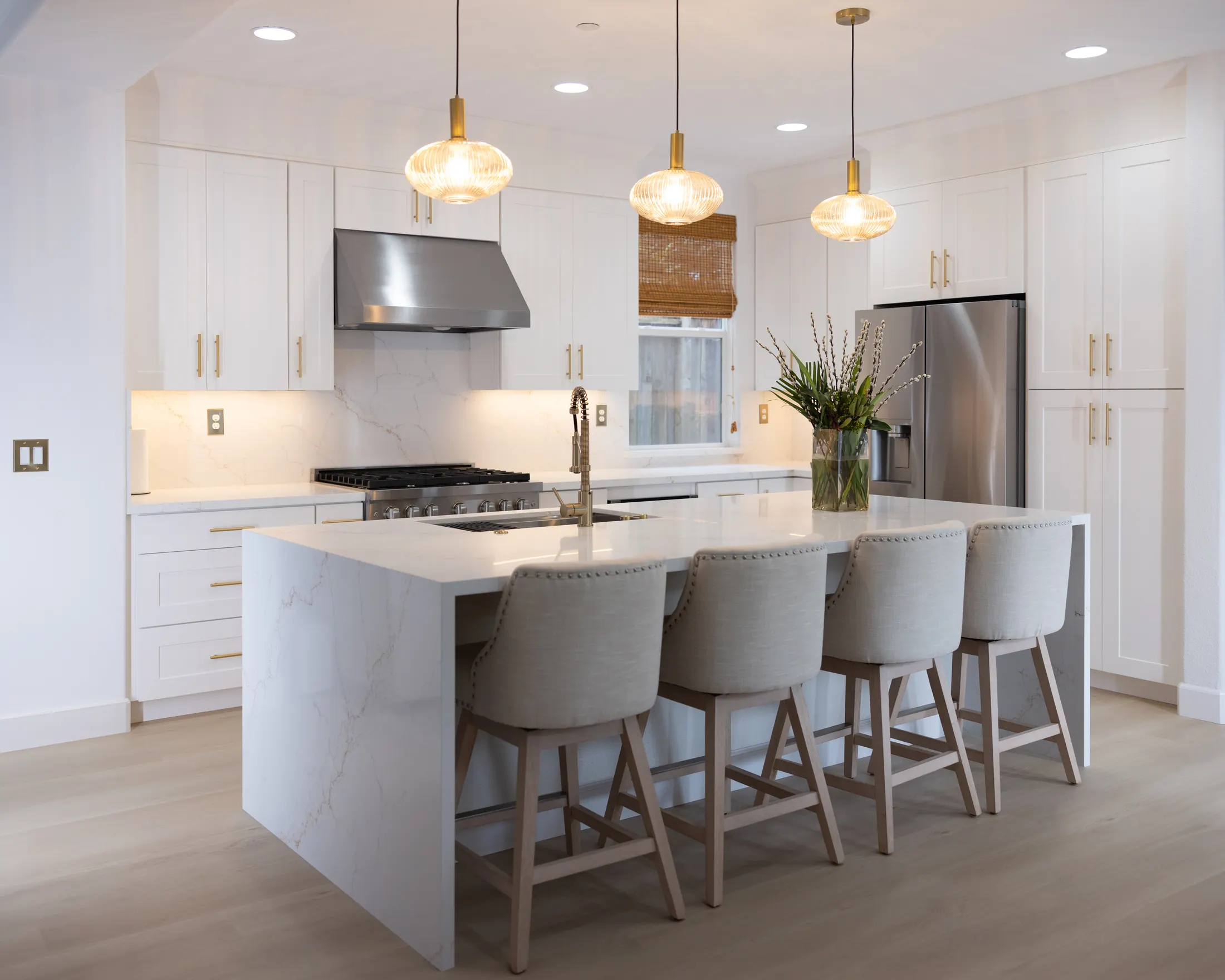RCA kitchen remodel with white cabinets, quartz island, and pendant lighting