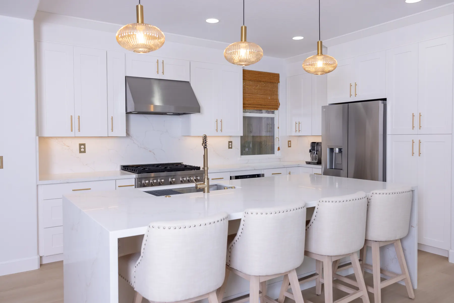 RCA kitchen remodel with white island, pendant lights, and full-height cabinets
